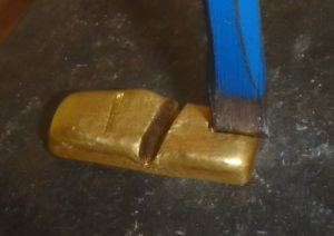 Marking the 24K gold bar the chisel